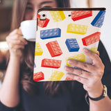 a girl is holding and viewing personalized iPad folio case with Retro Game design