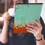 a girl is holding and viewing personalized iPad folio case with Rusted Metal design